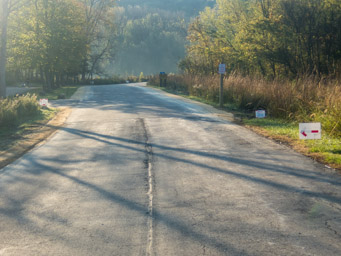 Turn off the road, three signs visible