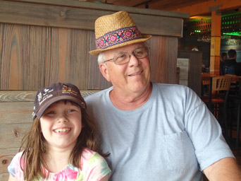 Jeralyn and Pop-Pop trade hats in the Funky Pelican